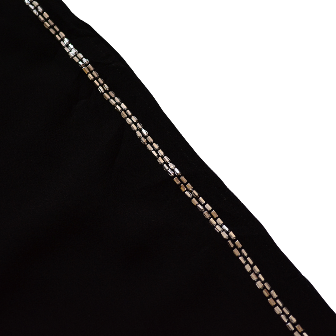 Pantalón negro de gasa con canutillo